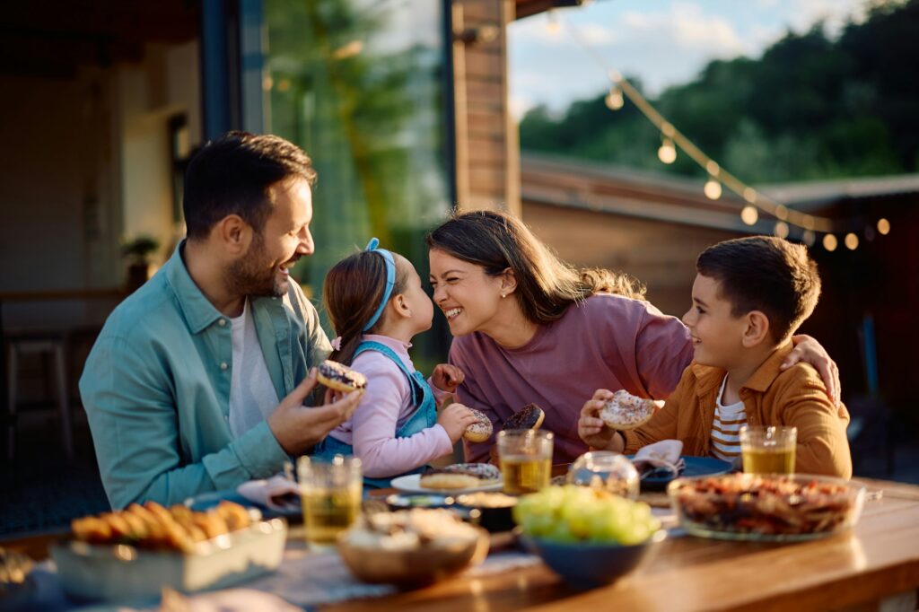 Cheerful family enjoying in meal on a patio.